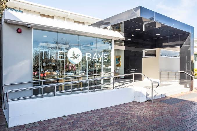 The Bays Hospital entrance with its glass frontage and logo